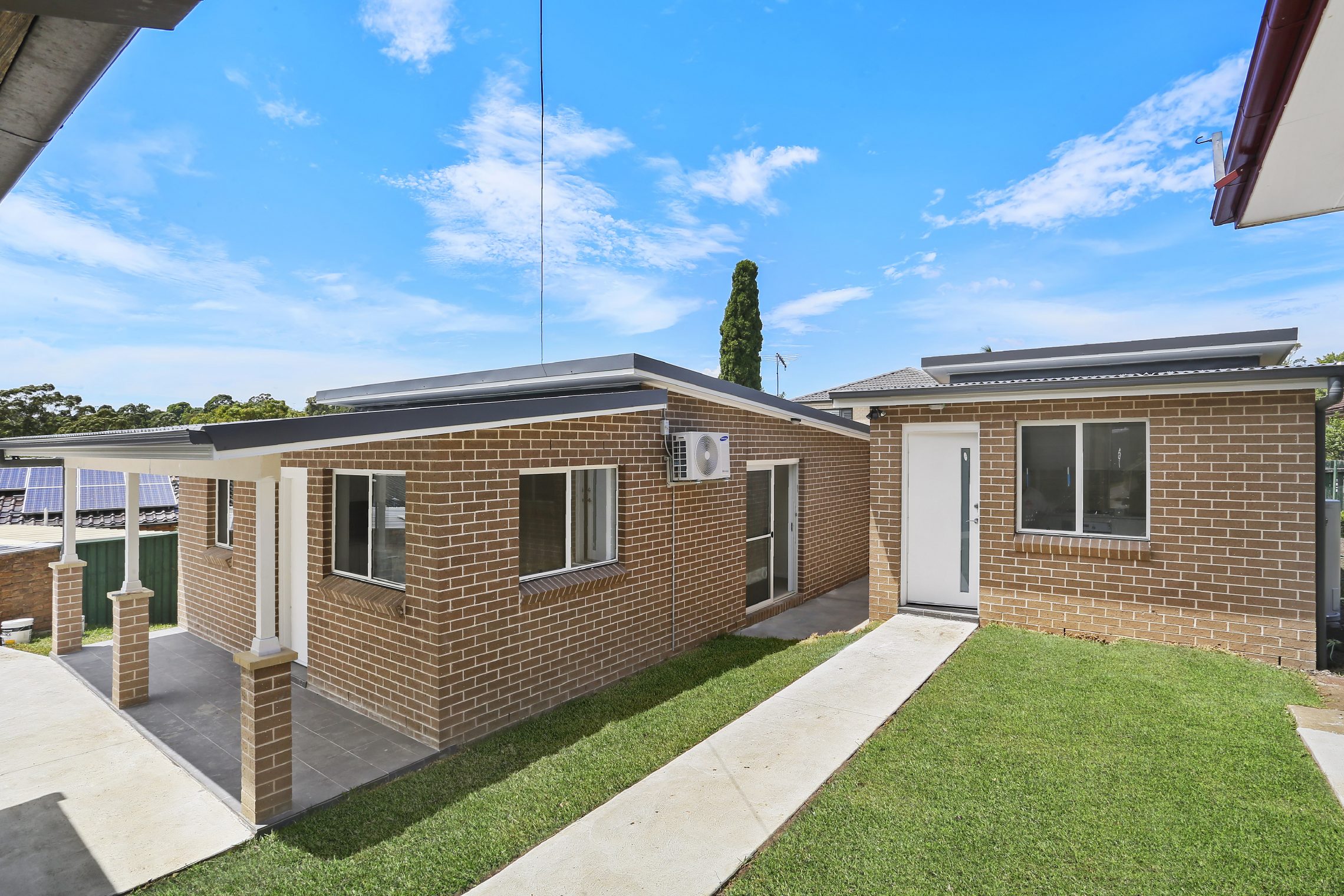 Two brick granny flats side by side to one another