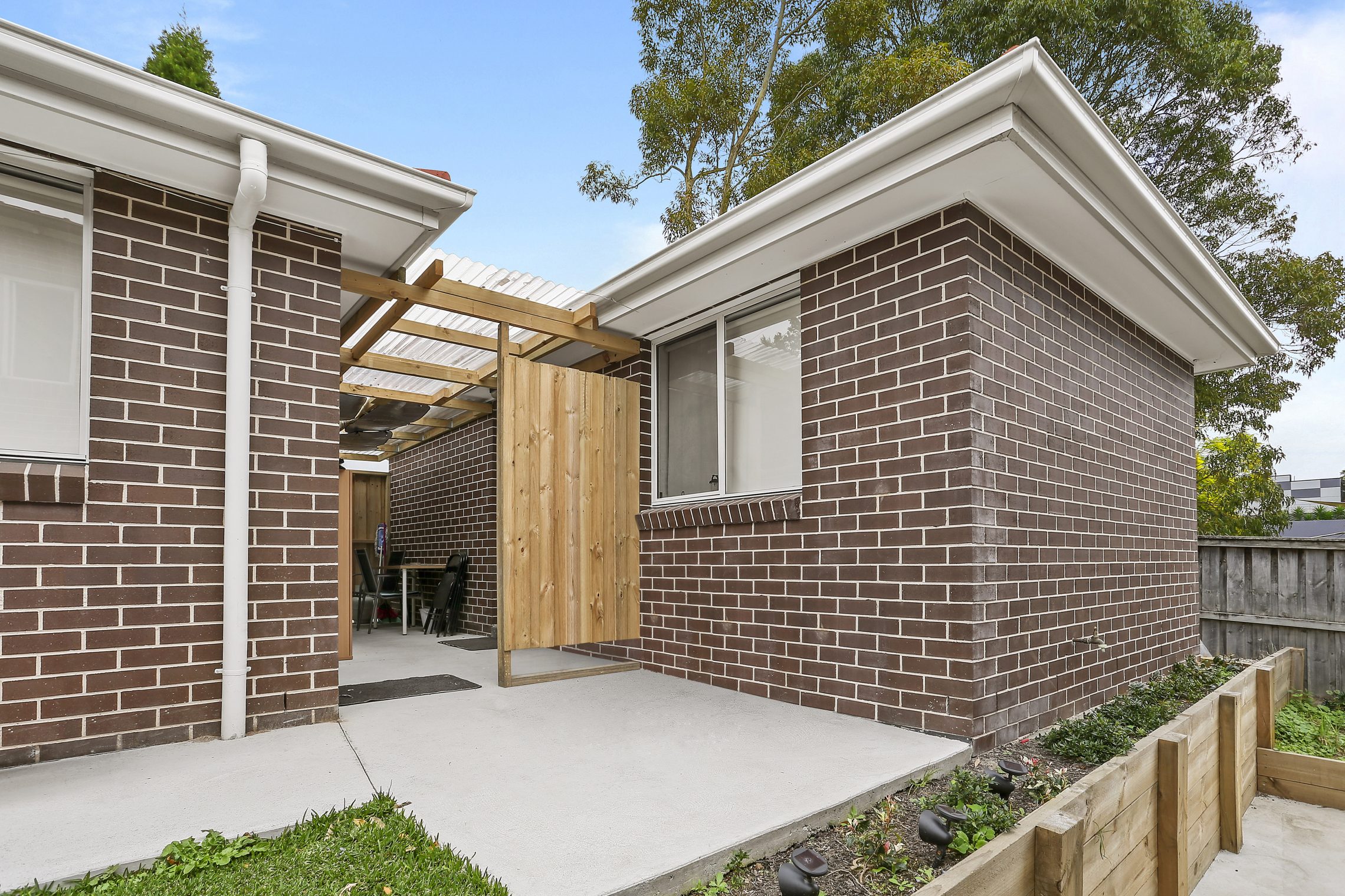 Two flats side by side with sheltered courtyard between the two brick buildings