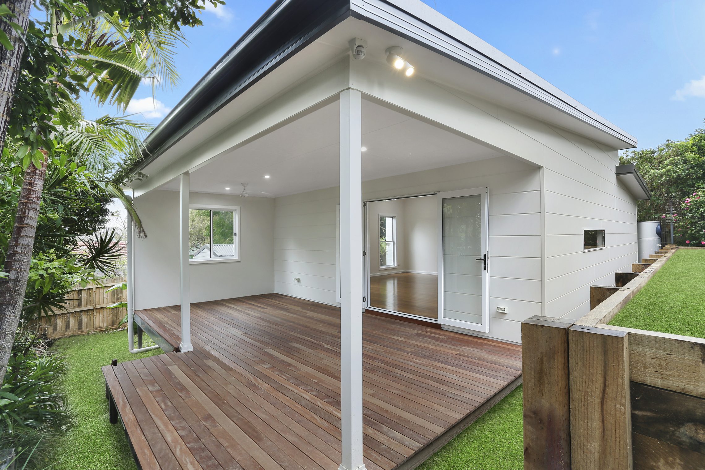 Beautiful covered wooden porch with side wall and window