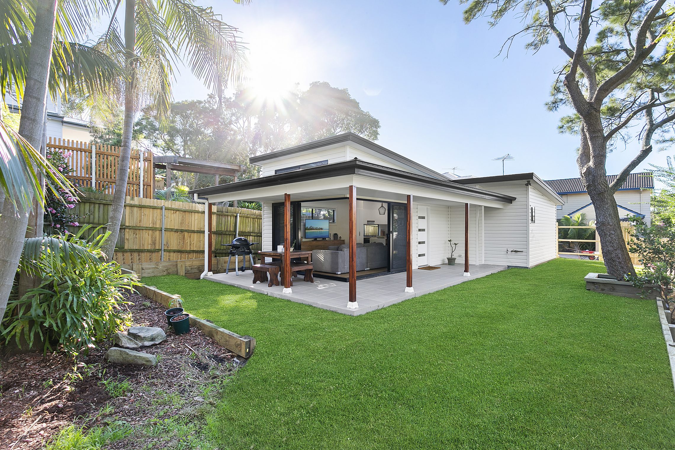 Granny flat with large wraparound overhand and patio with open corner entry point