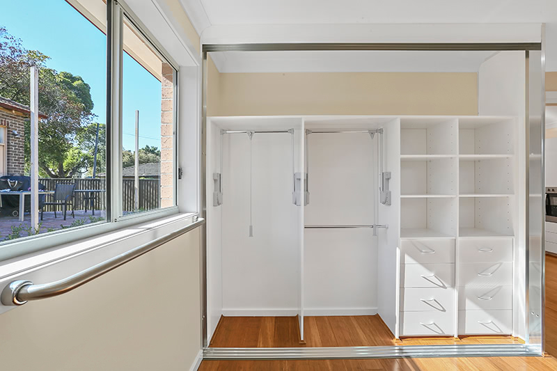 multi-compartment closet with hand rails