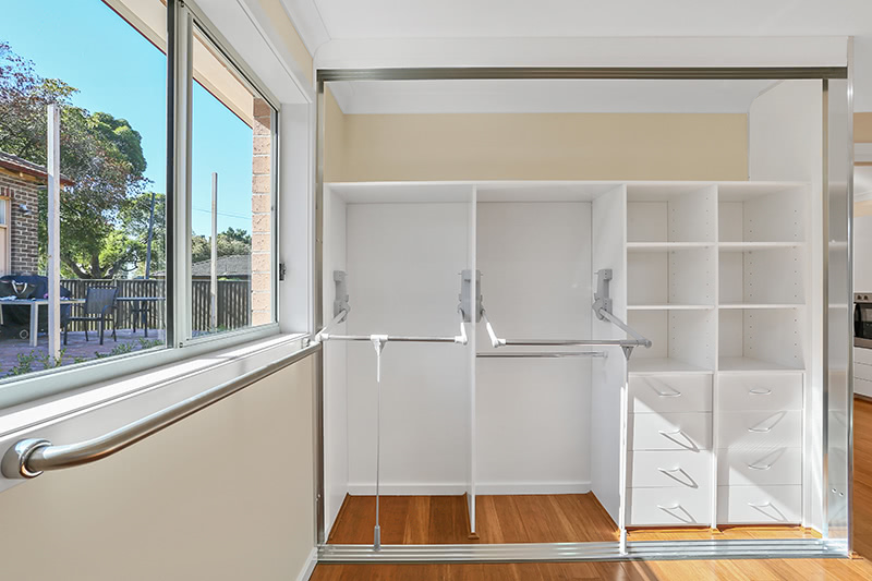 multi-compartment closet with hand rail