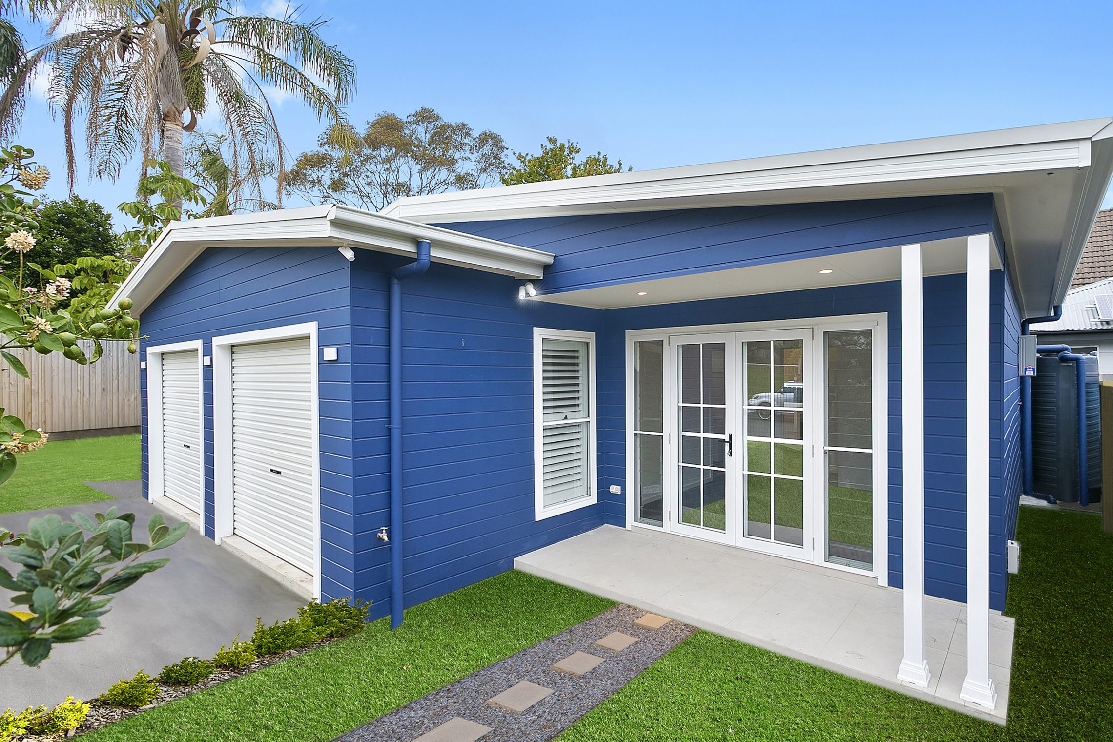 Ocean blue granny flat with two car garage and covered entry point