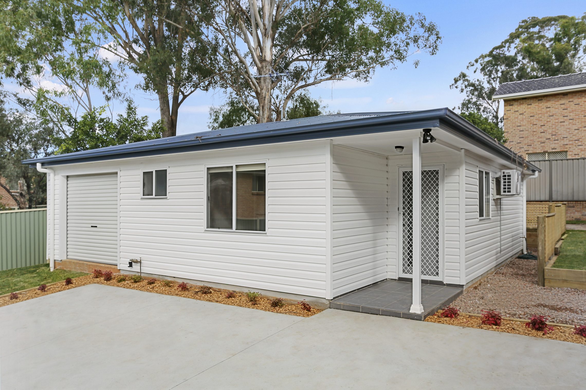 Granny flat with small garage, driveway and covered entry