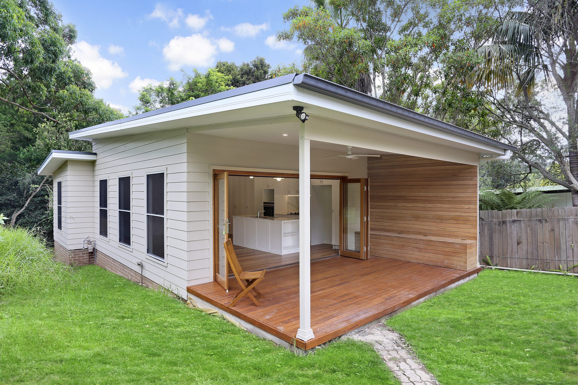 Beautiful wooden patio with wooden side wall and built in bench