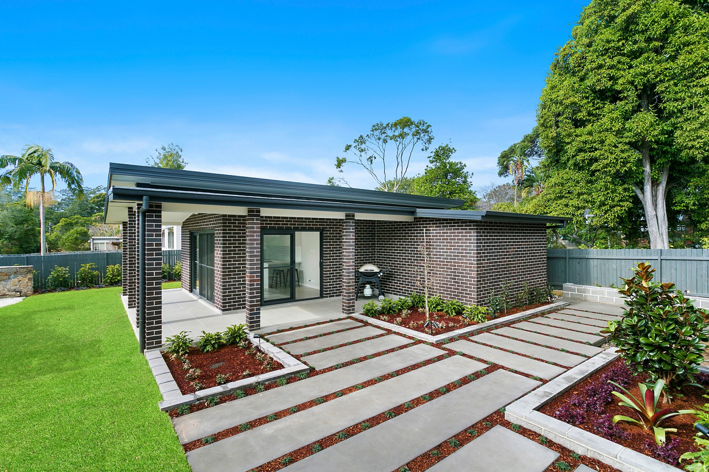 Brick granny flat with walk-around walkway and courtyard