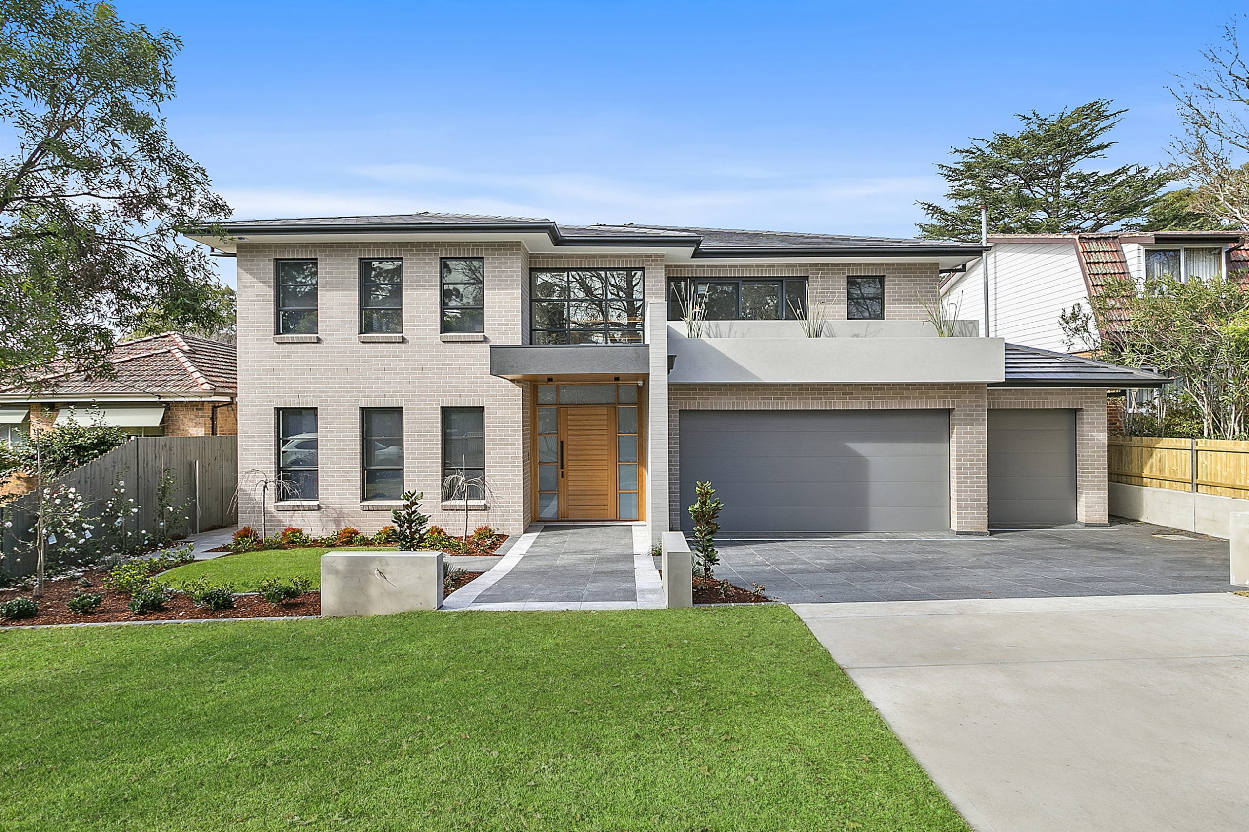 two story home with 3 car garage and wooden front door