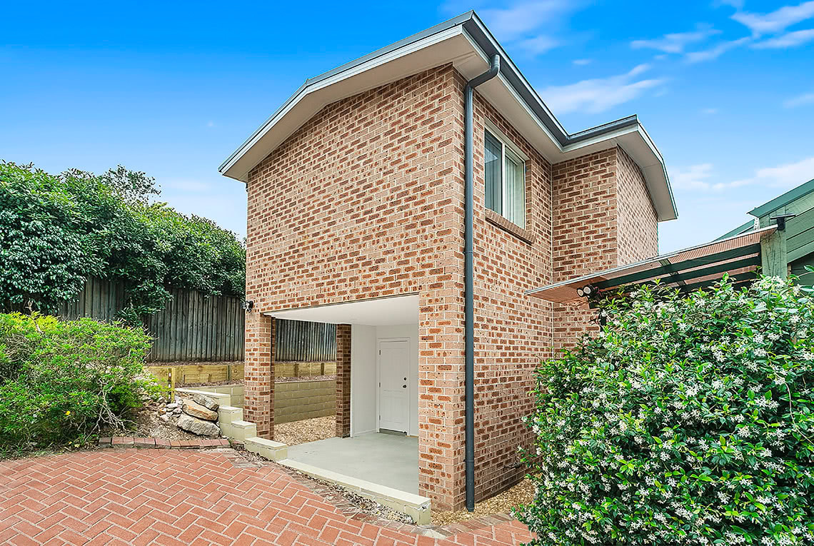 A Large two storey brick home with brick courtyard and covered front entry