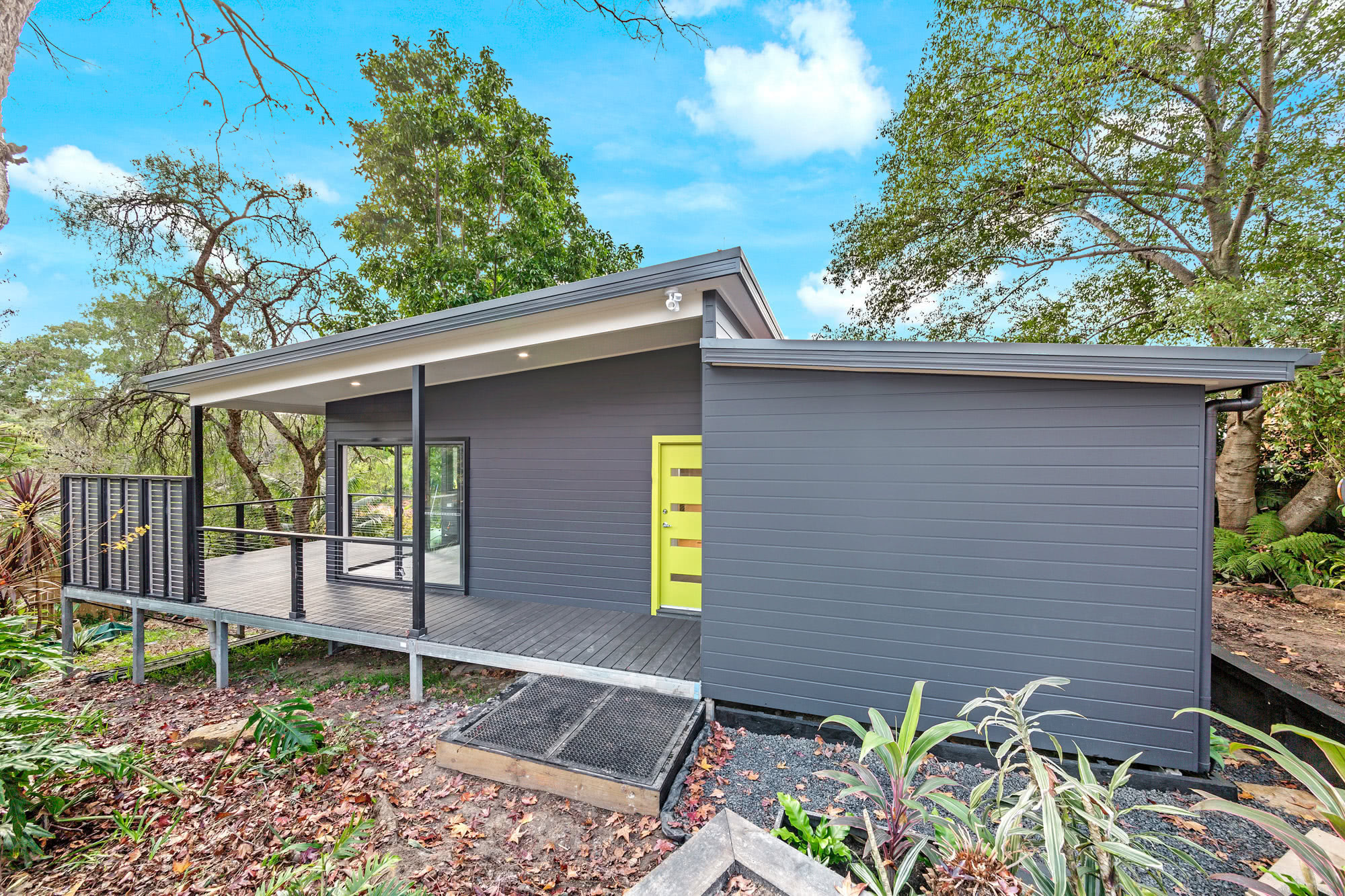 Large modern gray granny flat with patio overlooking bush