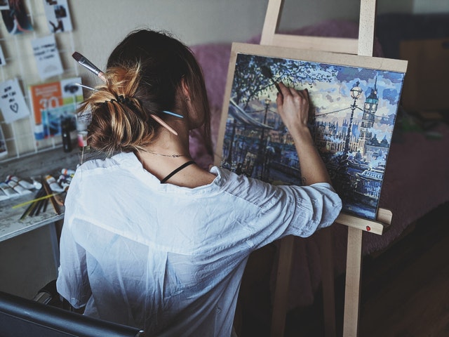 woman painting in home art studio