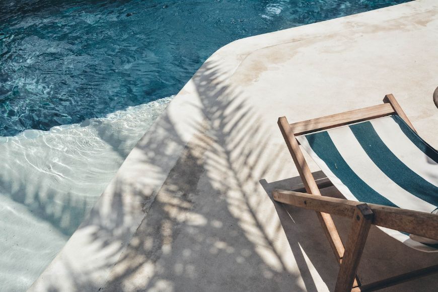 Striped pool chair next to outdoor pool