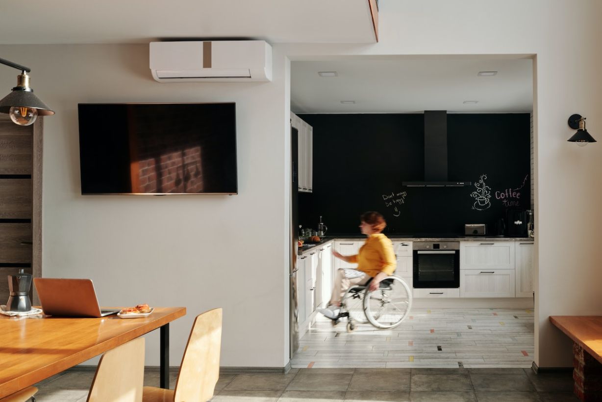 Woman in wheelchair inside kitchen