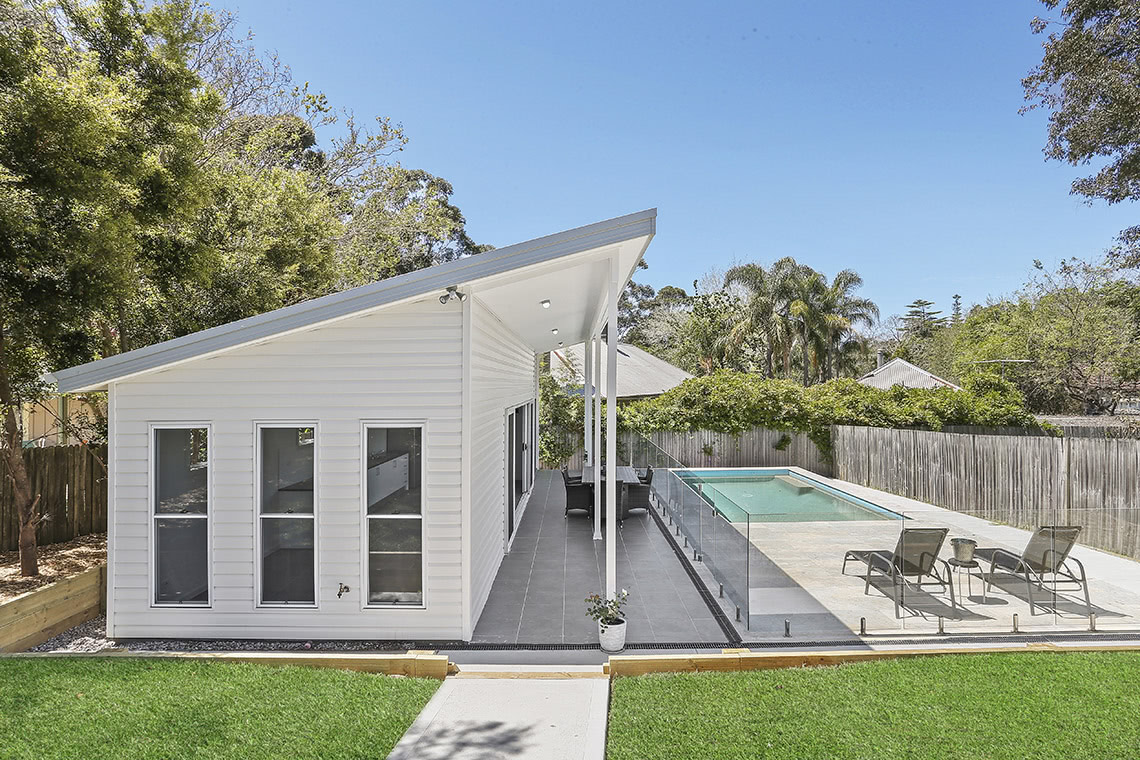 Profile view of white flat with pool