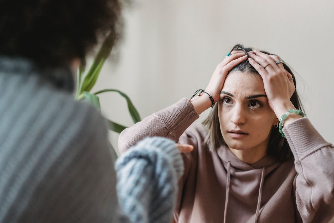 Woman holding her head in frusteration