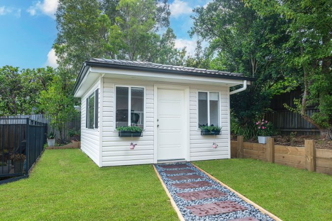 White granny flat in backyard